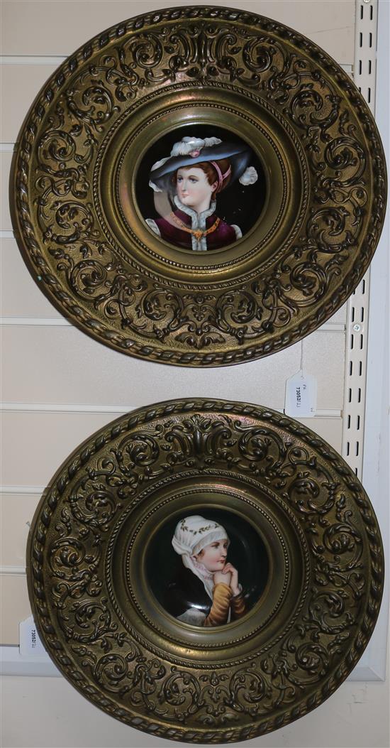 A pair of 19th century Continental porcelain plaques, with embossed brass frames